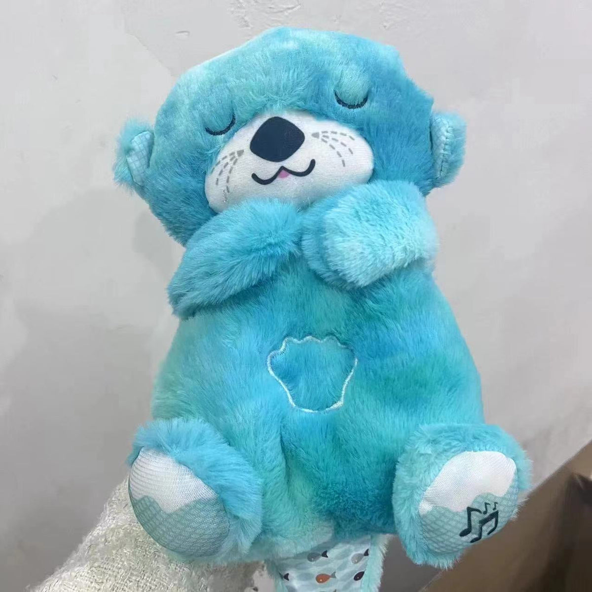 Máquina de sonido Lontra Acurrúcate y Tranquiliza Juguete de peluche portátil para bebé con detalles sensoriales música luces y movimiento rítmico de respiración
